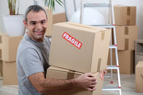 Professional movers carrying furniture in a Wimbledon flat move